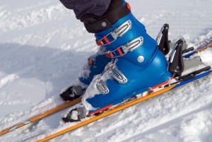 a pair of blue ski boots securely fastened to the skis.