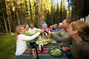 A group "cheers"-ing at a table during a glamping trip near Aspen.