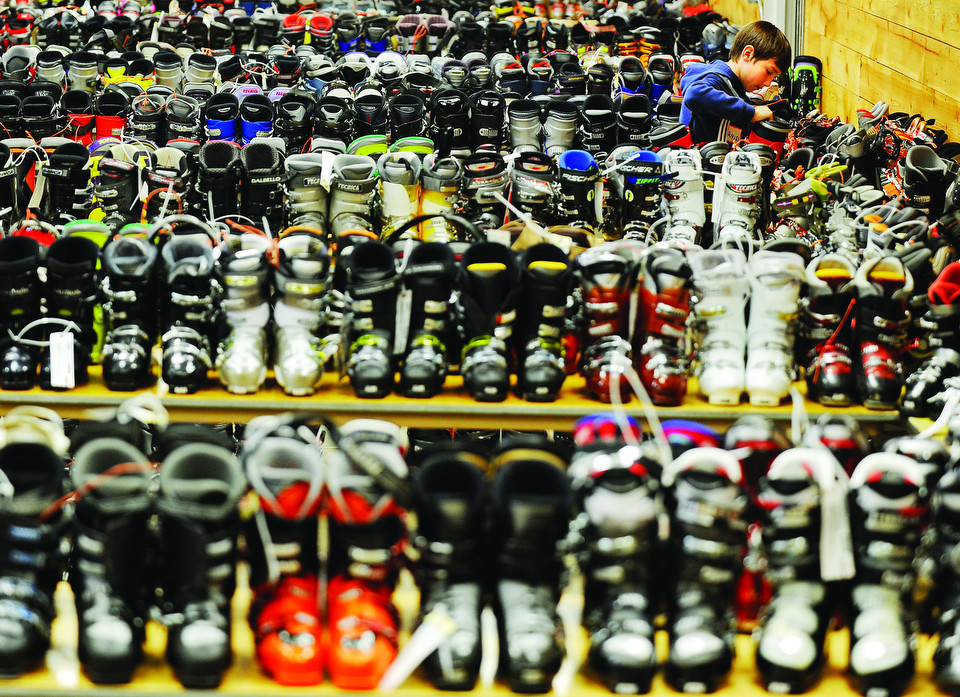 Bridger Ski Foundation Ski Swap volunteer Ansel Brayton finds a spot to squeeze a pair of ski boots onto a table in preparation for today's BSF Ski Swap at the Gallatin County Fairgrounds. Doors open at Saturday at 9 a.m. for BSF members and 10 a.m. for the general public.