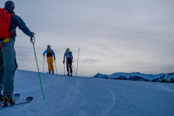 A group of cross-country skiers in Aspen uphill skiing on a nordic trail.