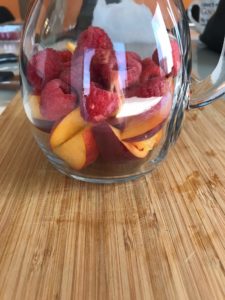 peaches raspberries pitcher