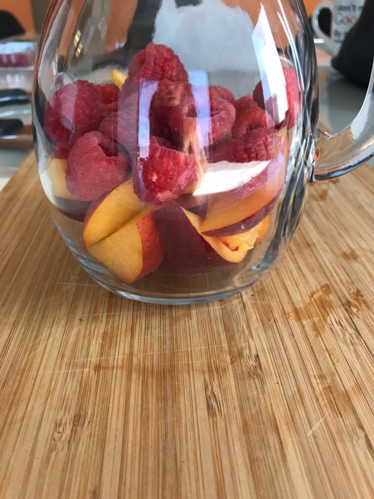 peaches raspberries pitcher 