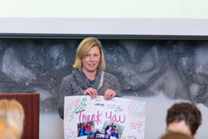 Woman holding a thank you card at the Limelight Ketchum community fund.