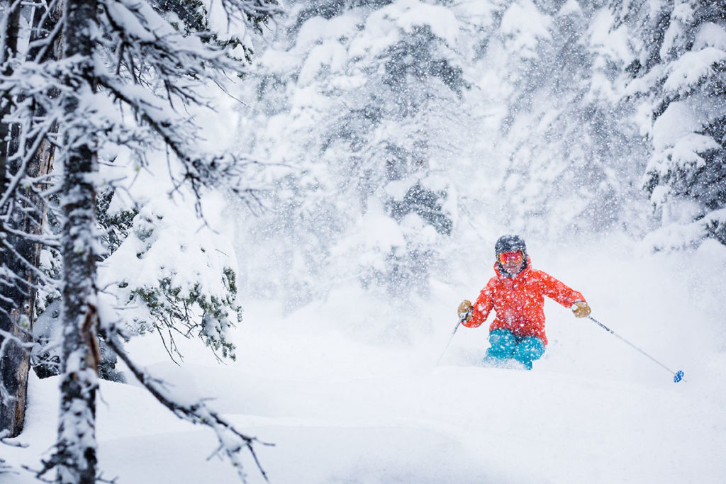 A skier going down through the fresh powder on the Village Express ski run at Snowmass.