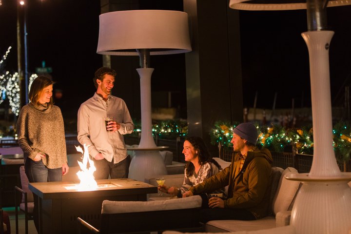 A group gathering around a fire for après ski at the Limelight Lounge.