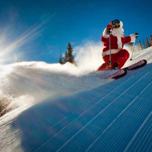Celebrating the holidays in the mountains - santa skiing