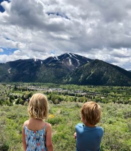 Young children looking at the view of the ski area near the Limelight Ketchum Hotel.