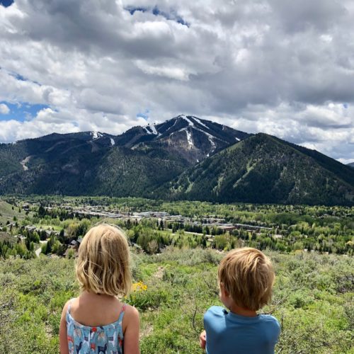 Young children looking at the view of the ski area near the Limelight Ketchum Hotel.