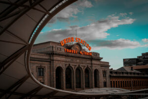 Denver's Union Station at sunset with neon sign illuminated.