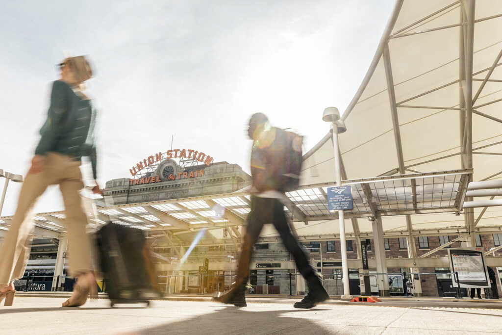 Travelers walking by Denver's Union Station in the morning